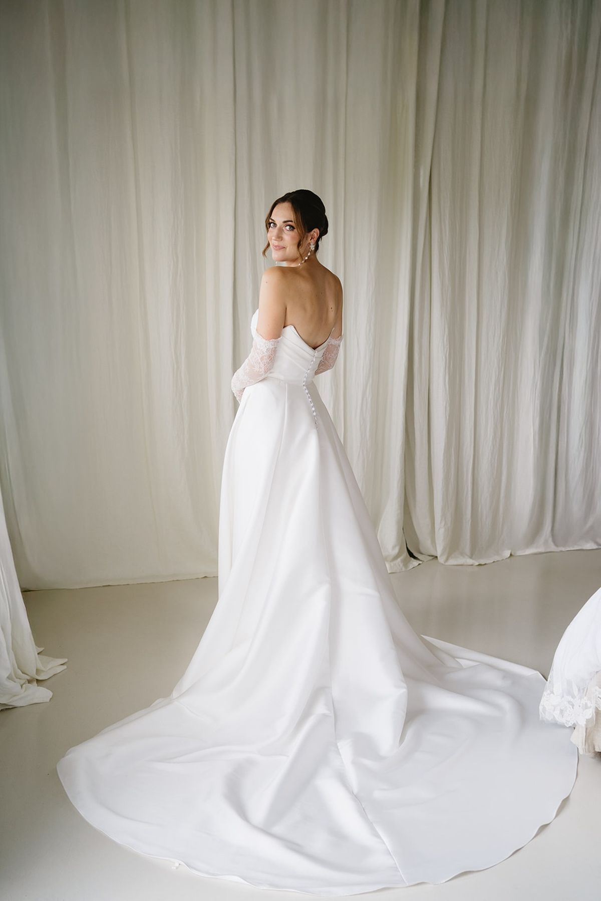 Bride showing dress back and long train at Les Domaines de Patras, Provence