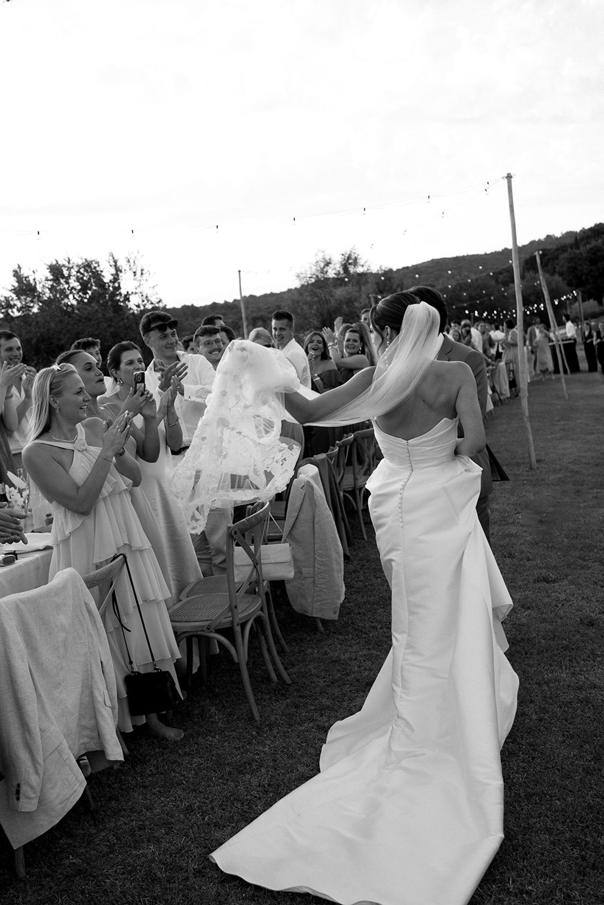 Bride and groom reception entrance with guests cheering at Les Domaines de Patras, Provence