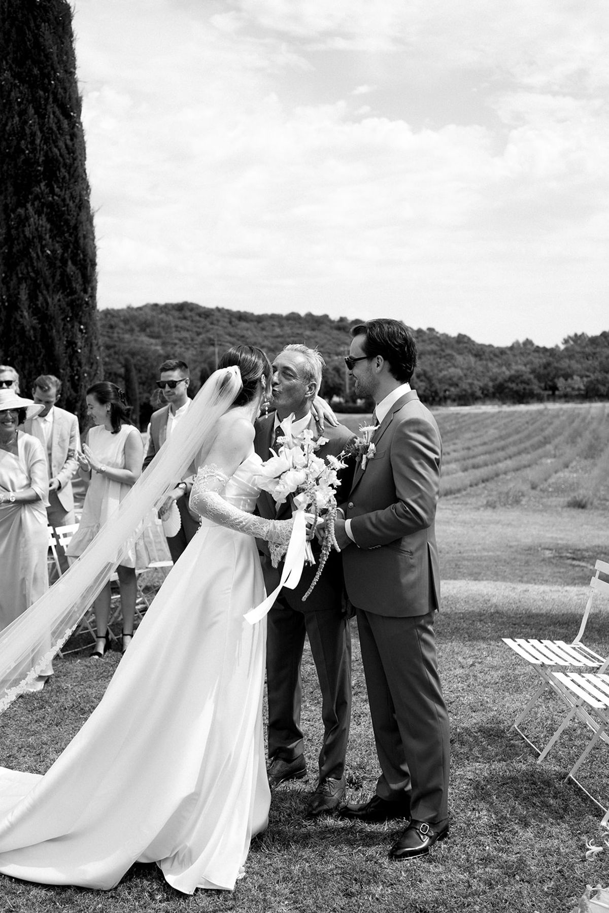 Father giving bride away to groom at altar at Les Domaines de Patras, Provence