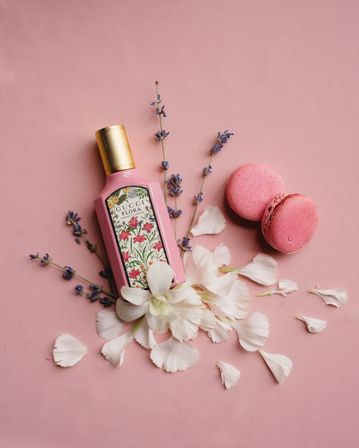 Bride's perfume and macaron flat lay on blush backdrop at Les Domaines de Patras, Provence
