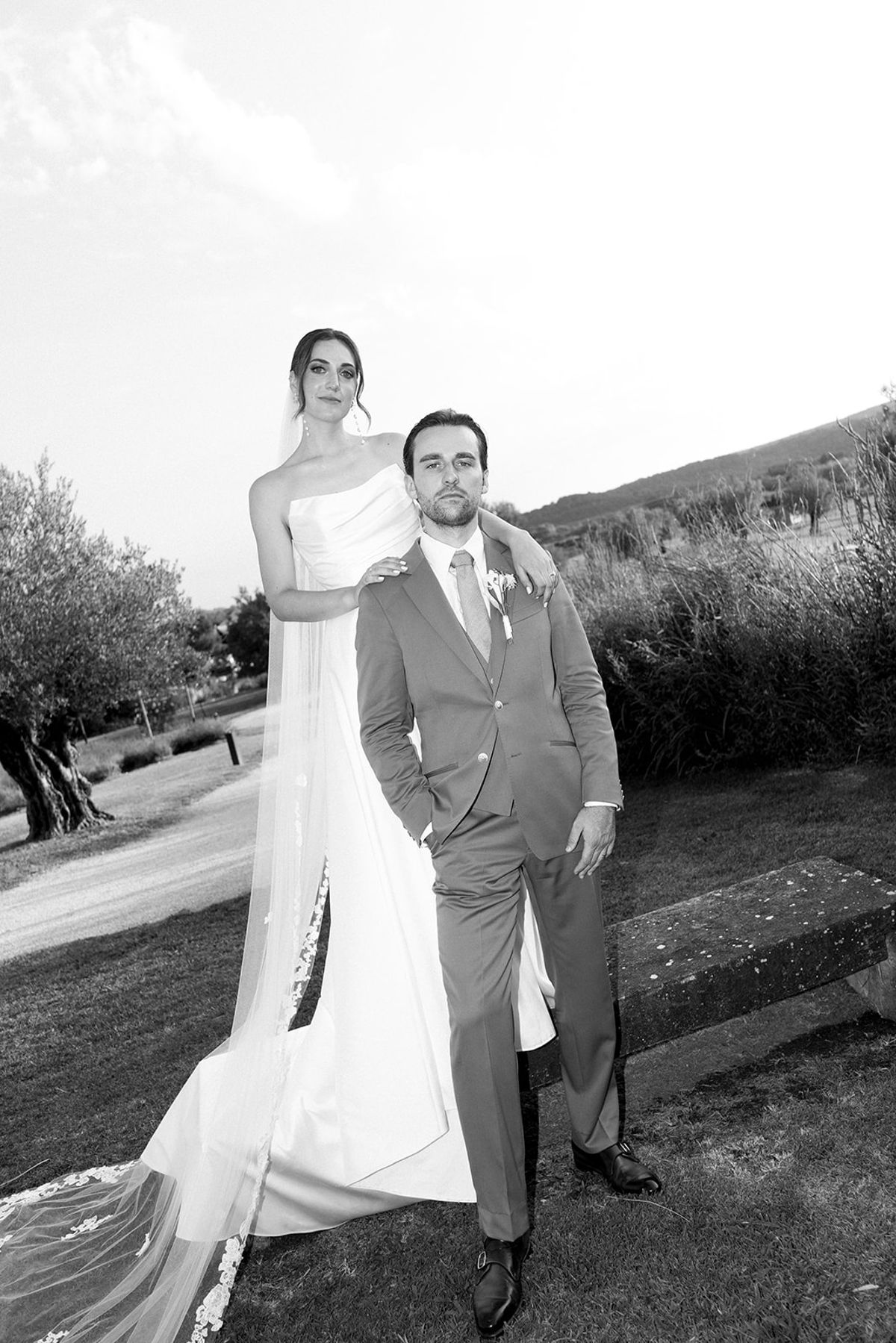 Bride standing behind groom in garden portrait at Les Domaines de Patras, Provence