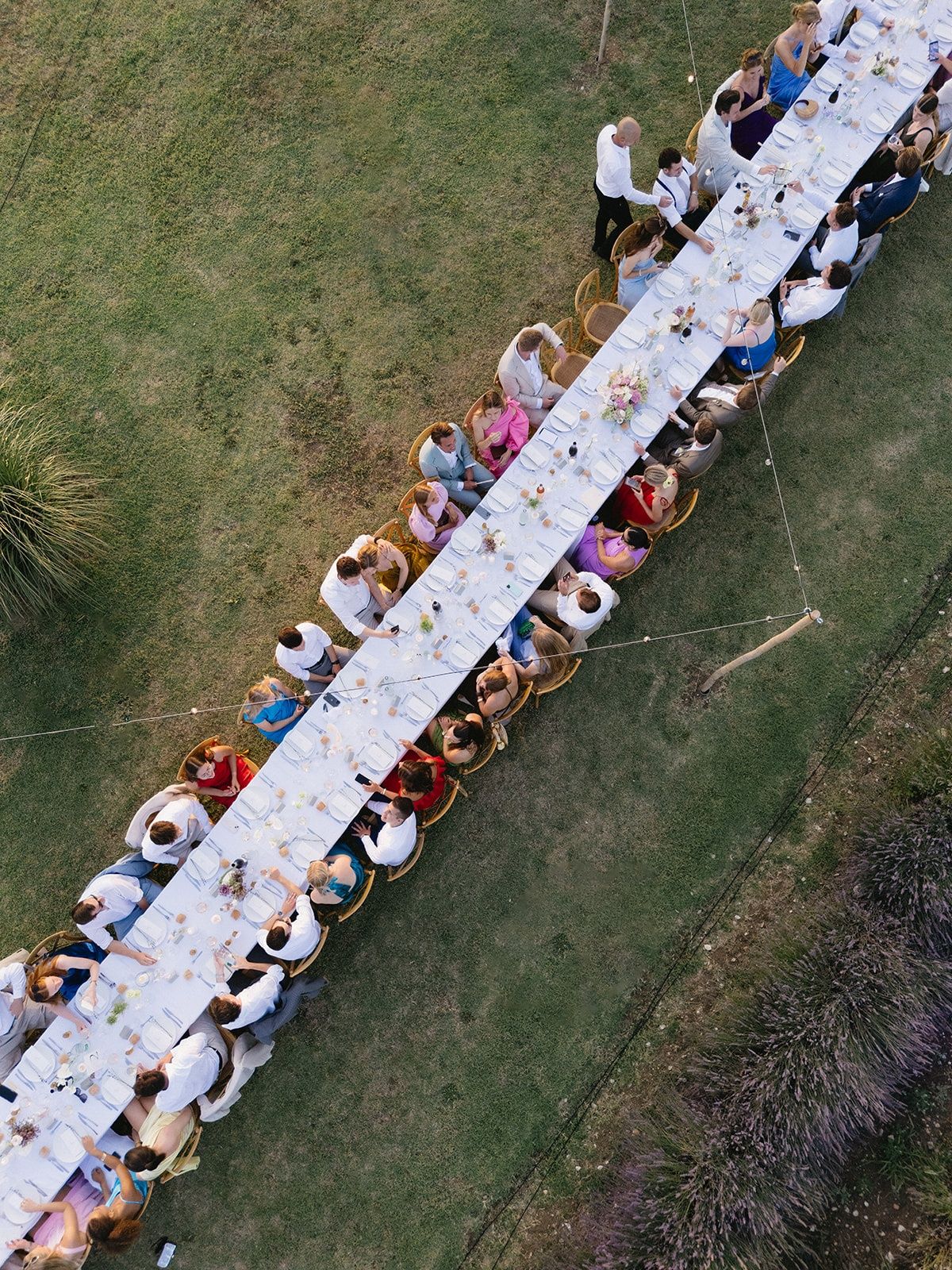 Aerial view of long banquet table at golden hour at Les Domaines de Patras, Provence