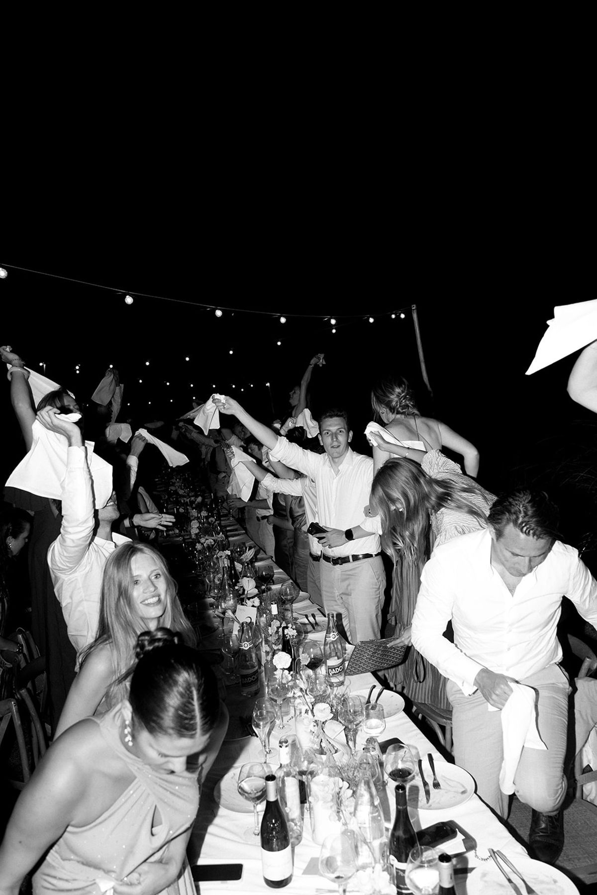 Guests waving napkins at night reception at Les Domaines de Patras, Provence