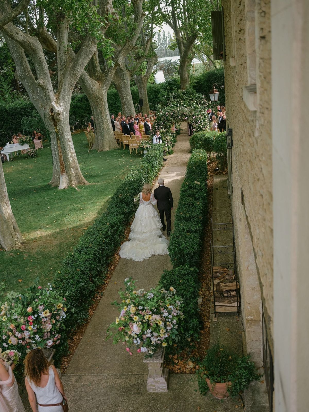 bride walking down the boxwood aisle with her father at La Bastide de Laurence, Provence
