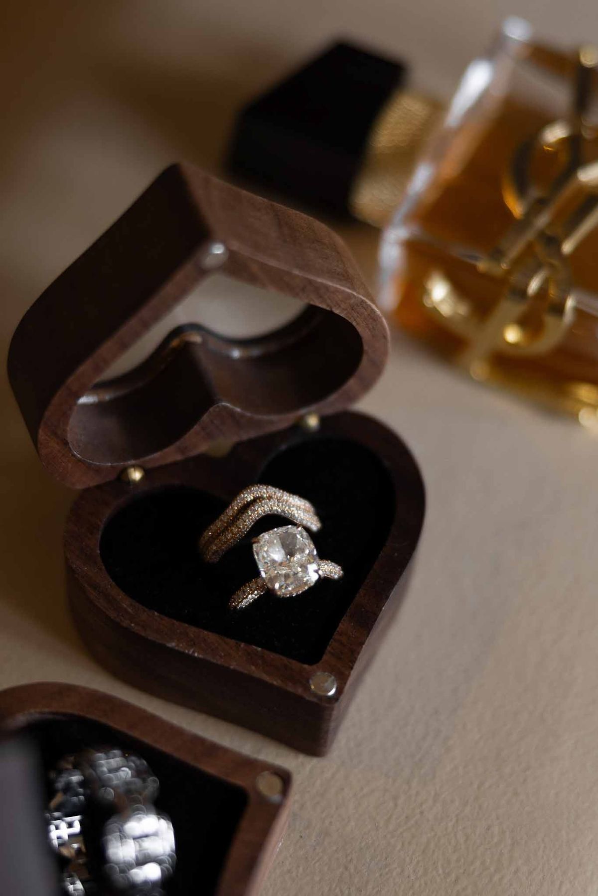 Diamond engagement ring and wedding band in walnut heart-shaped box at Parc Mougins