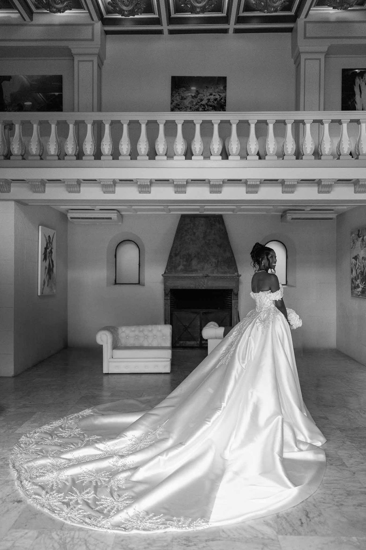 Bride in embroidered ball gown in grand hall with balcony at Parc Mougins
