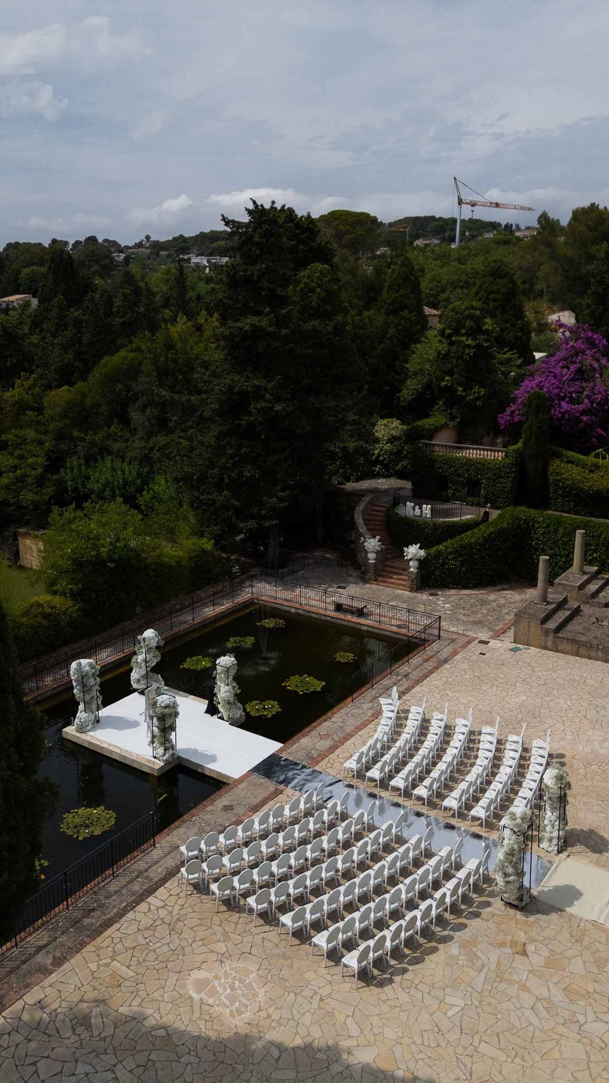 Ceremony area beside pond viewed from upper terrace at Parc Mougins