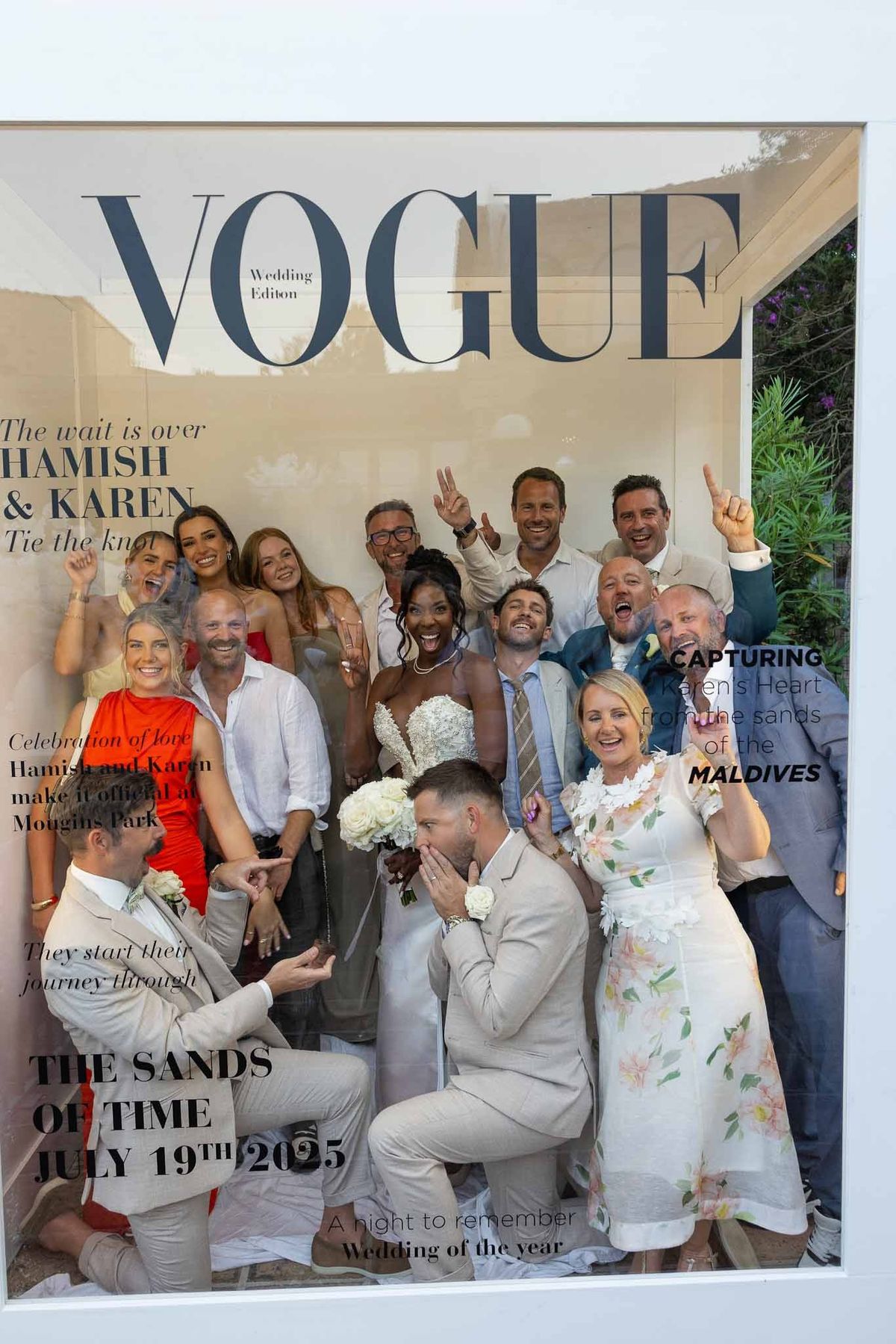 Wedding guests posing in Vogue photobooth with bride and groom at Parc Mougins
