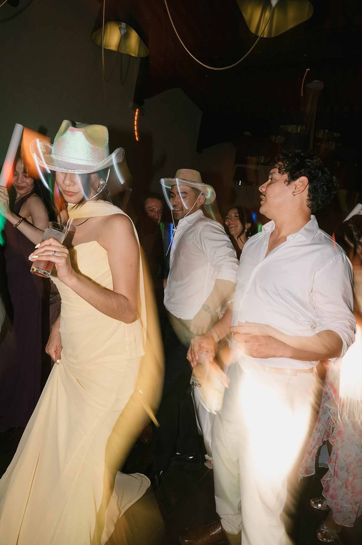 Couple dancing in cowboy hats at after-party at Abbaye de Talloires