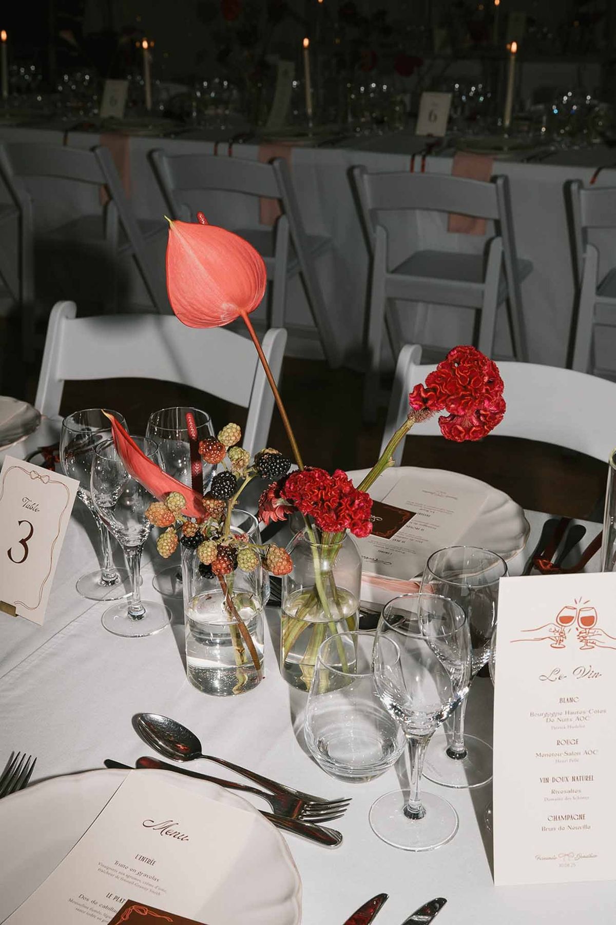 Red anthurium and carnation centrepiece with menu cards at Abbaye de Talloires