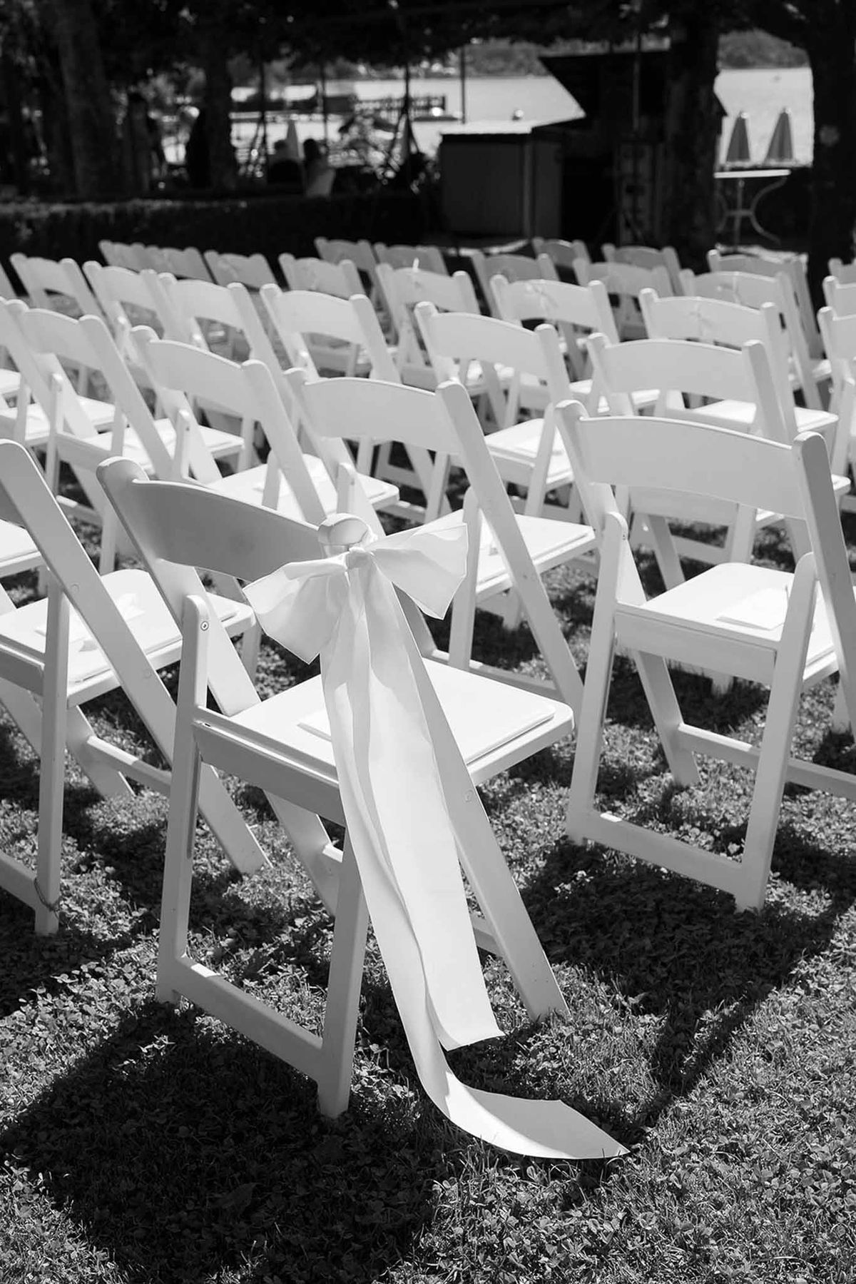 White ceremony chairs with ribbon bow detail in black and white at Abbaye de Talloires