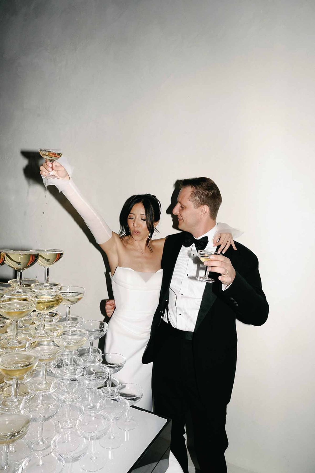 Couple embracing at champagne tower during dinner at Abbaye de Talloires