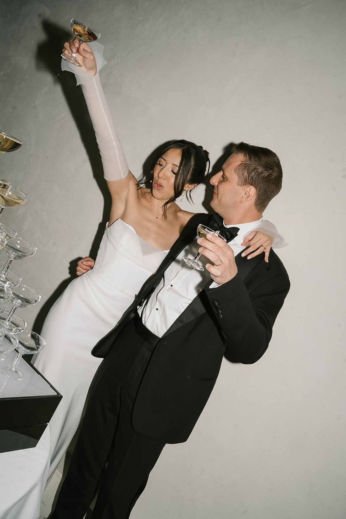 Couple celebrating after champagne tower pour at Abbaye de Talloires