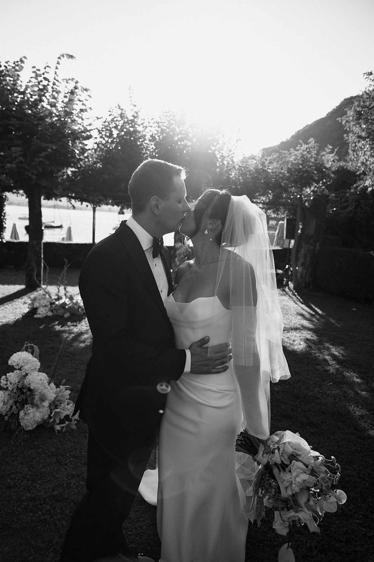 Couple kissing at ceremony in black and white at Abbaye de Talloires