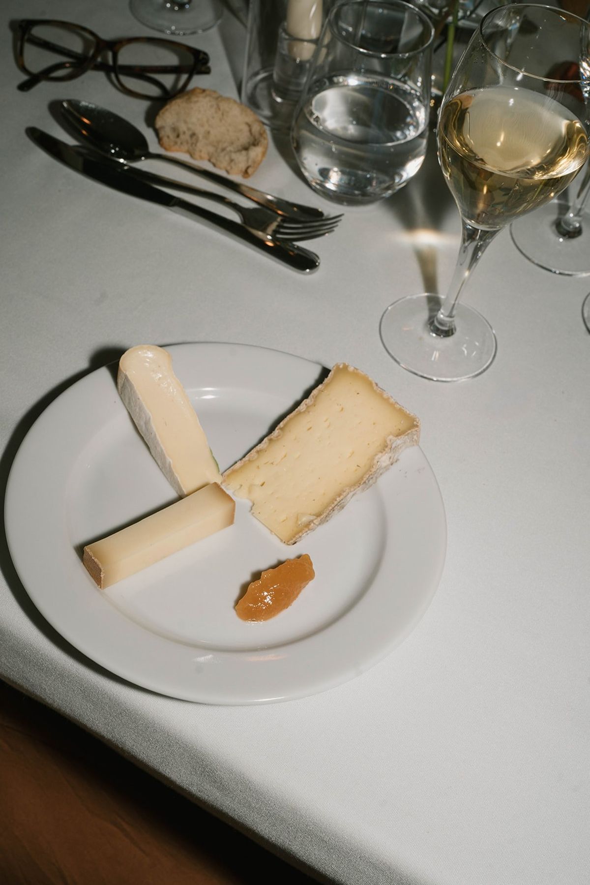 A regional cheese course with white wine on the dinner table at Abbaye de Talloires
