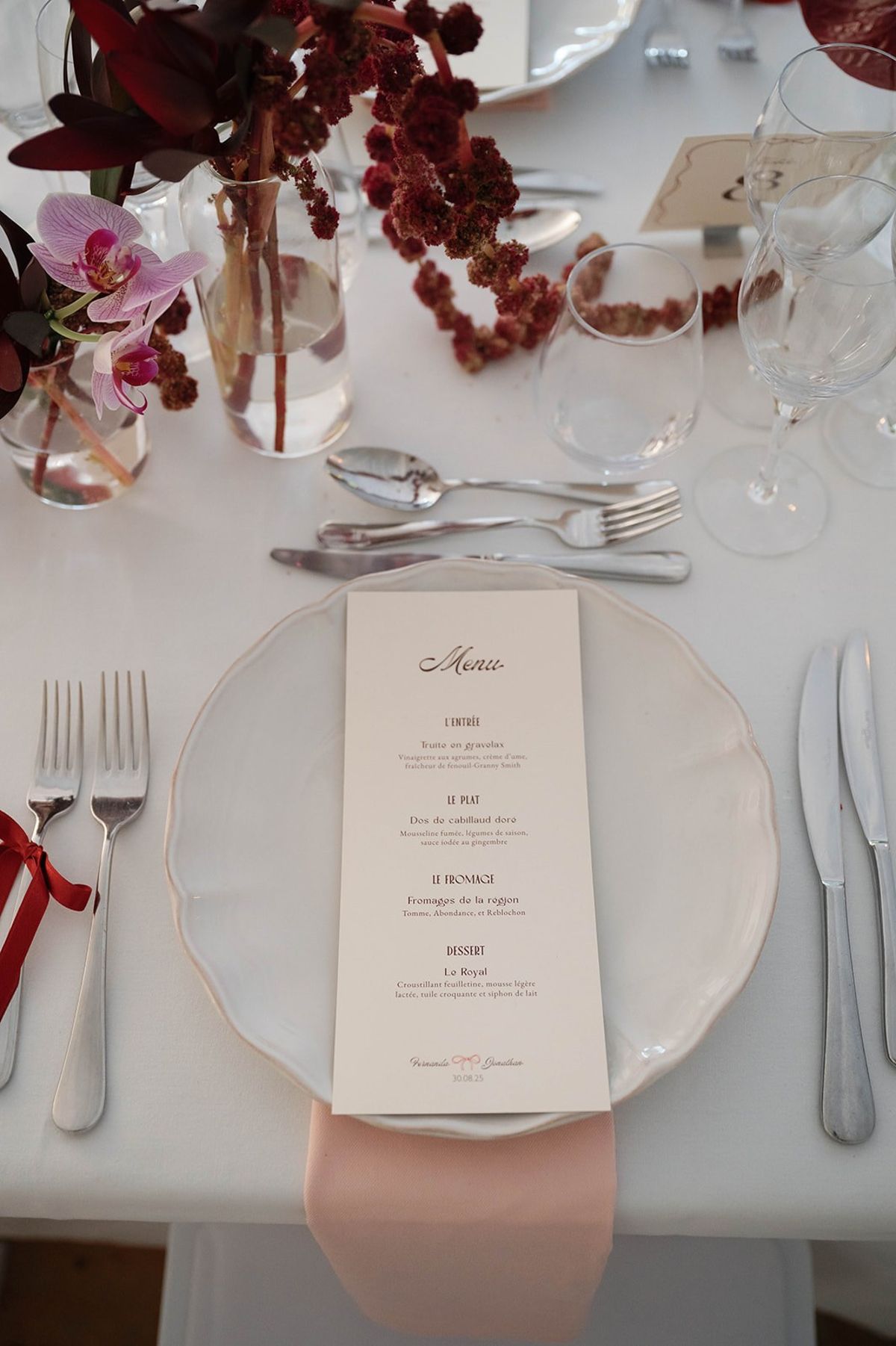 Illustrated menu card on a scalloped plate with amaranthus and orchid at Abbaye de Talloires