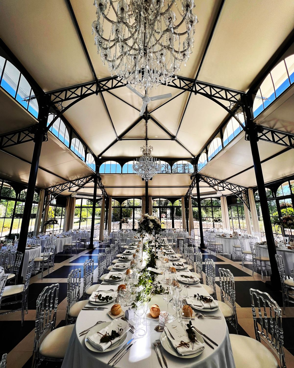 Black and white photo of wedding reception table setting with white roses