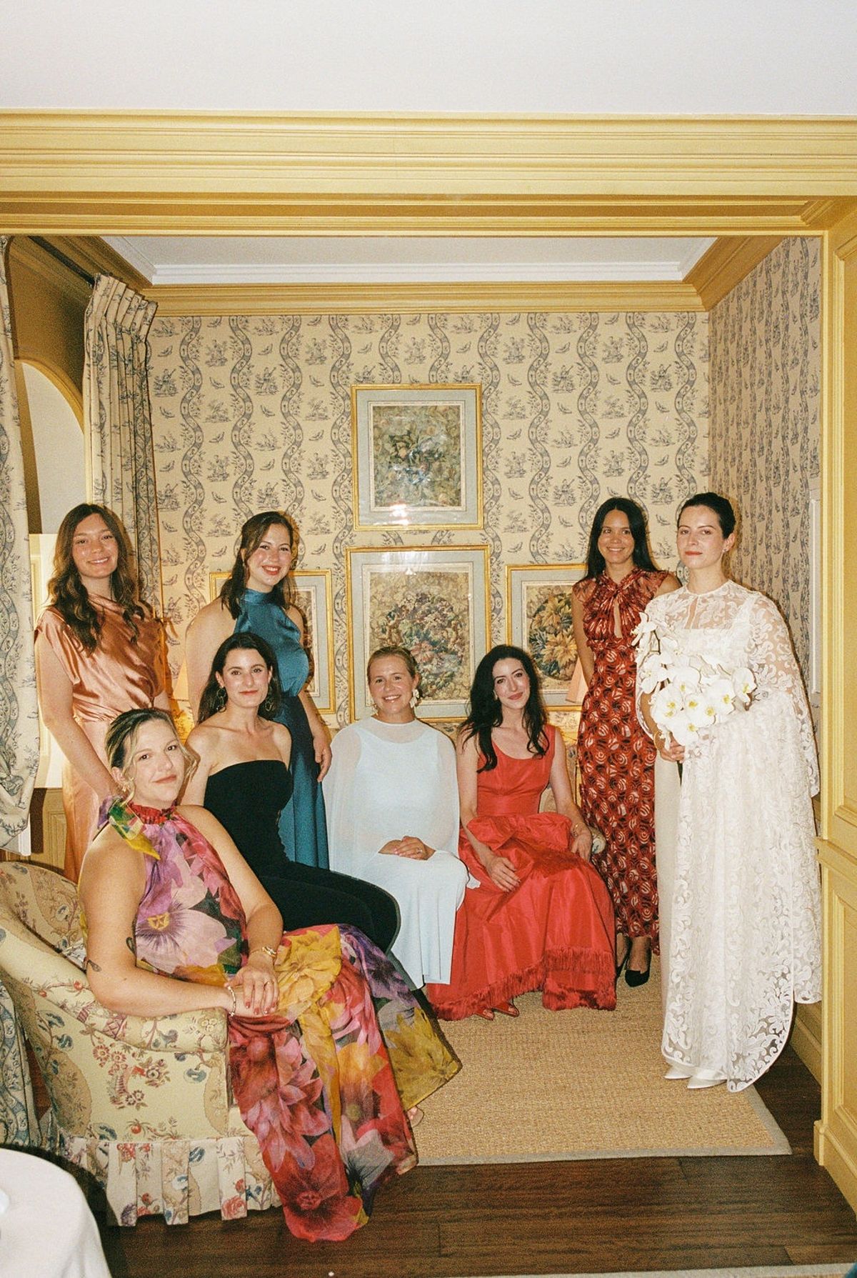 Formal bridal party portrait in chateau salon with bride centre in white dress