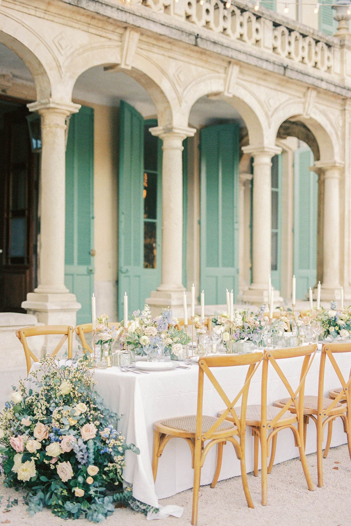 Wedding reception table setting in a garden with white roses