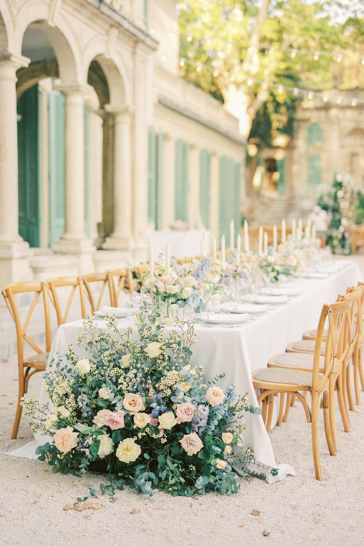 Wedding reception table setting in a garden with white roses
