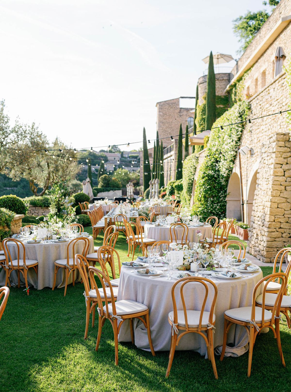 Wedding reception table setting in a garden with white roses
