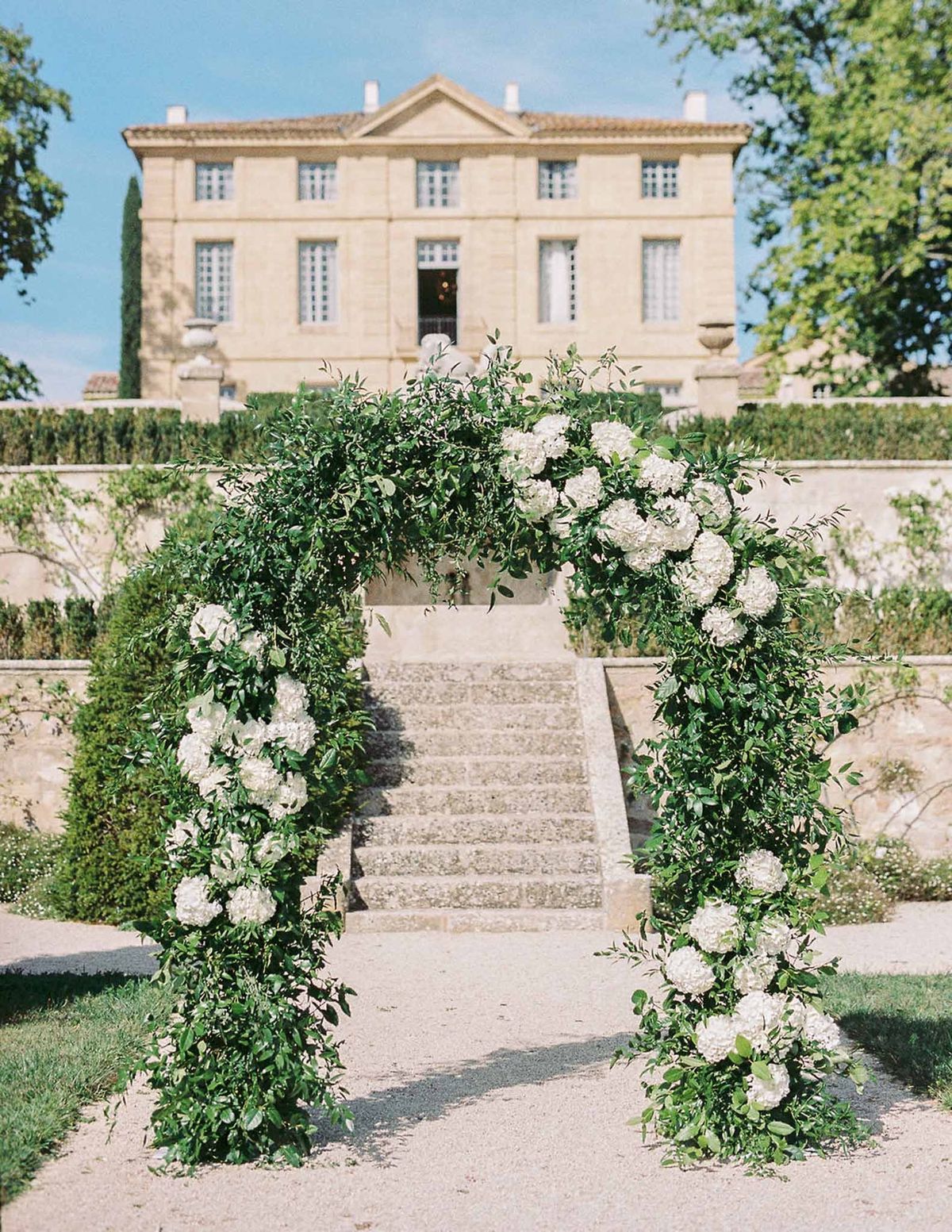 Greenery ceremony arch with white roses and hydrangeas at Château de la Gaude