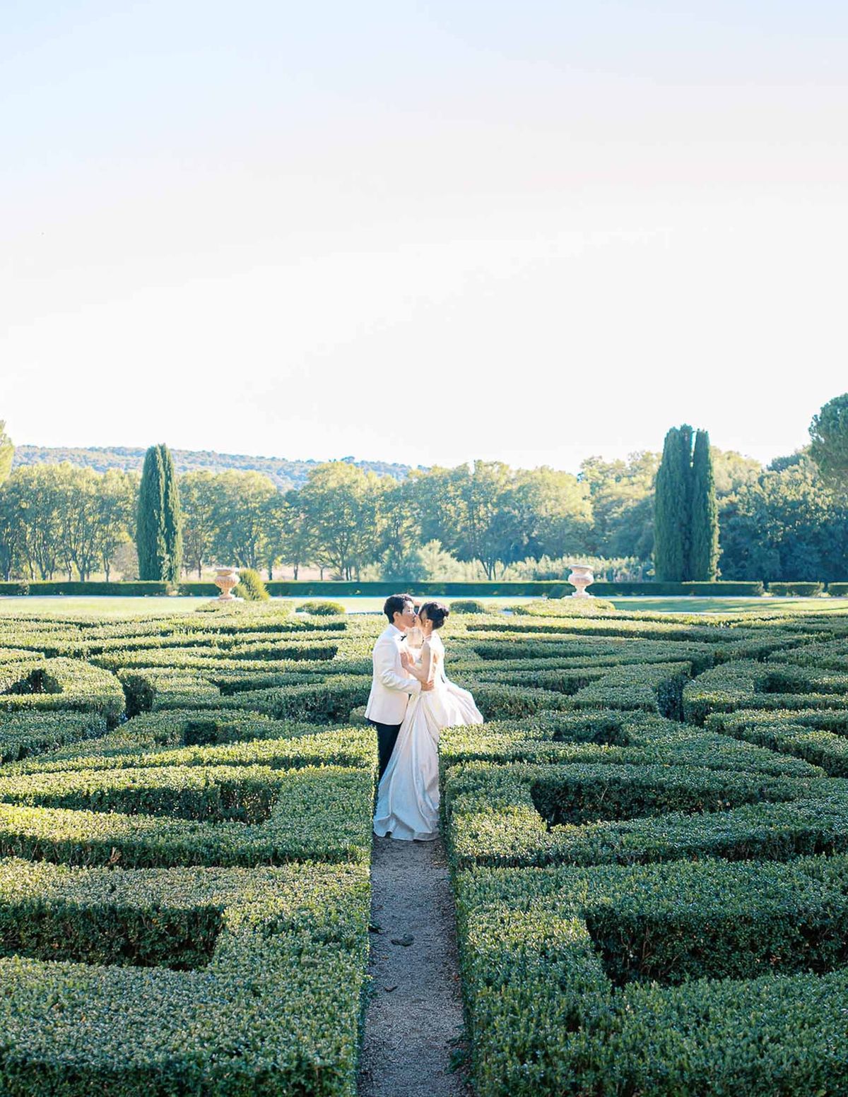 Couple kissing in parterre maze garden at golden hour at Château de la Gaude