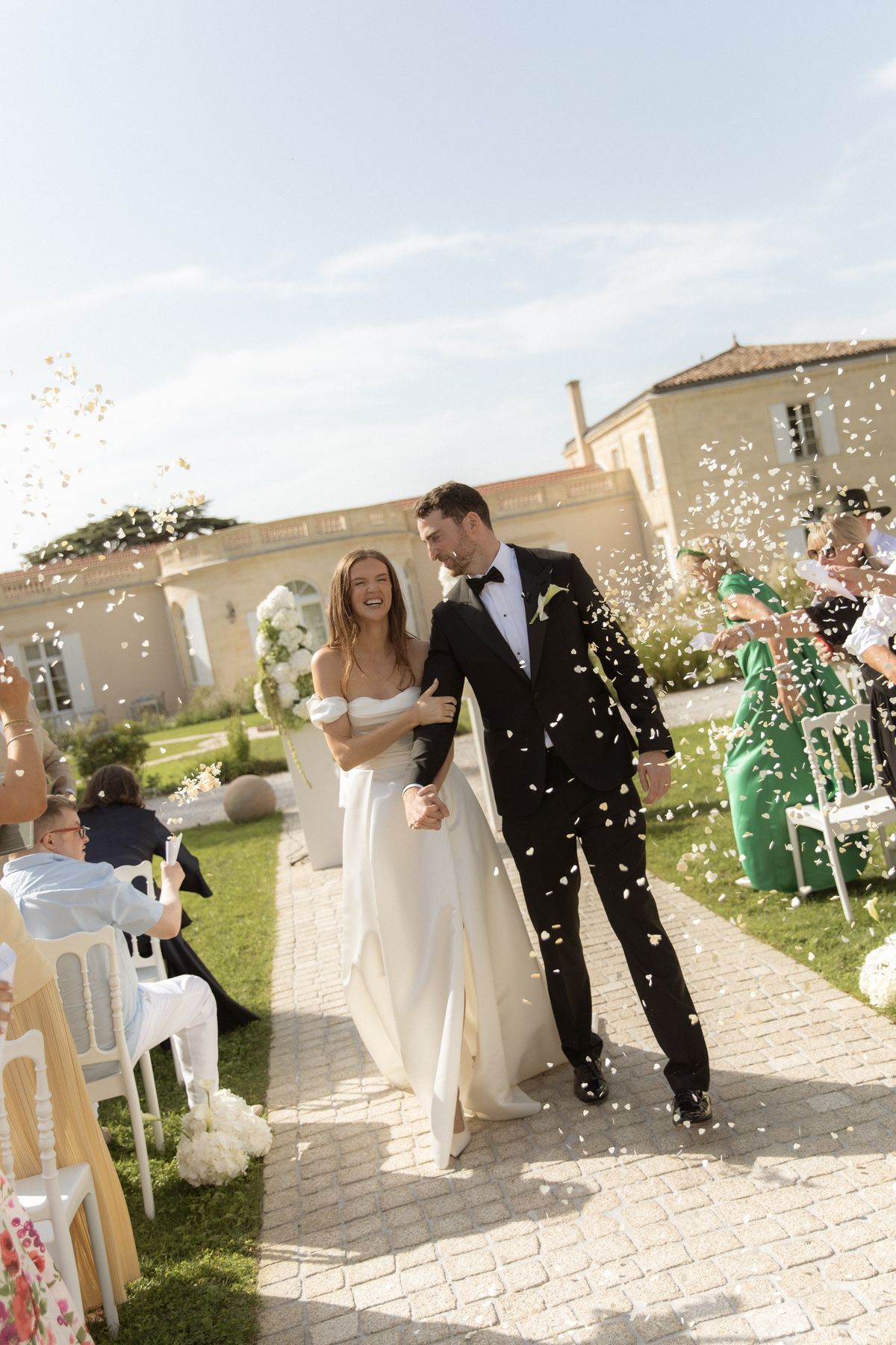 Bride and groom petal-toss recessional at Chateau Gassies, Nouvelle-Aquitaine