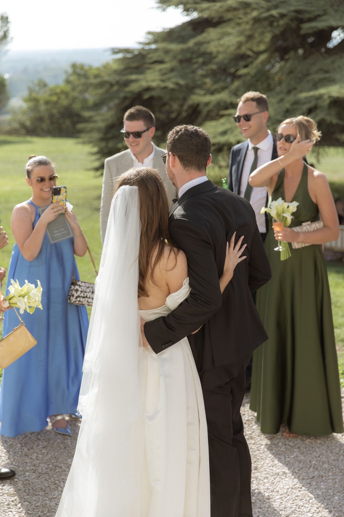 Bride and groom greeted by guests during cocktail hour at Chateau Gassies, Nouvelle-Aquitaine
