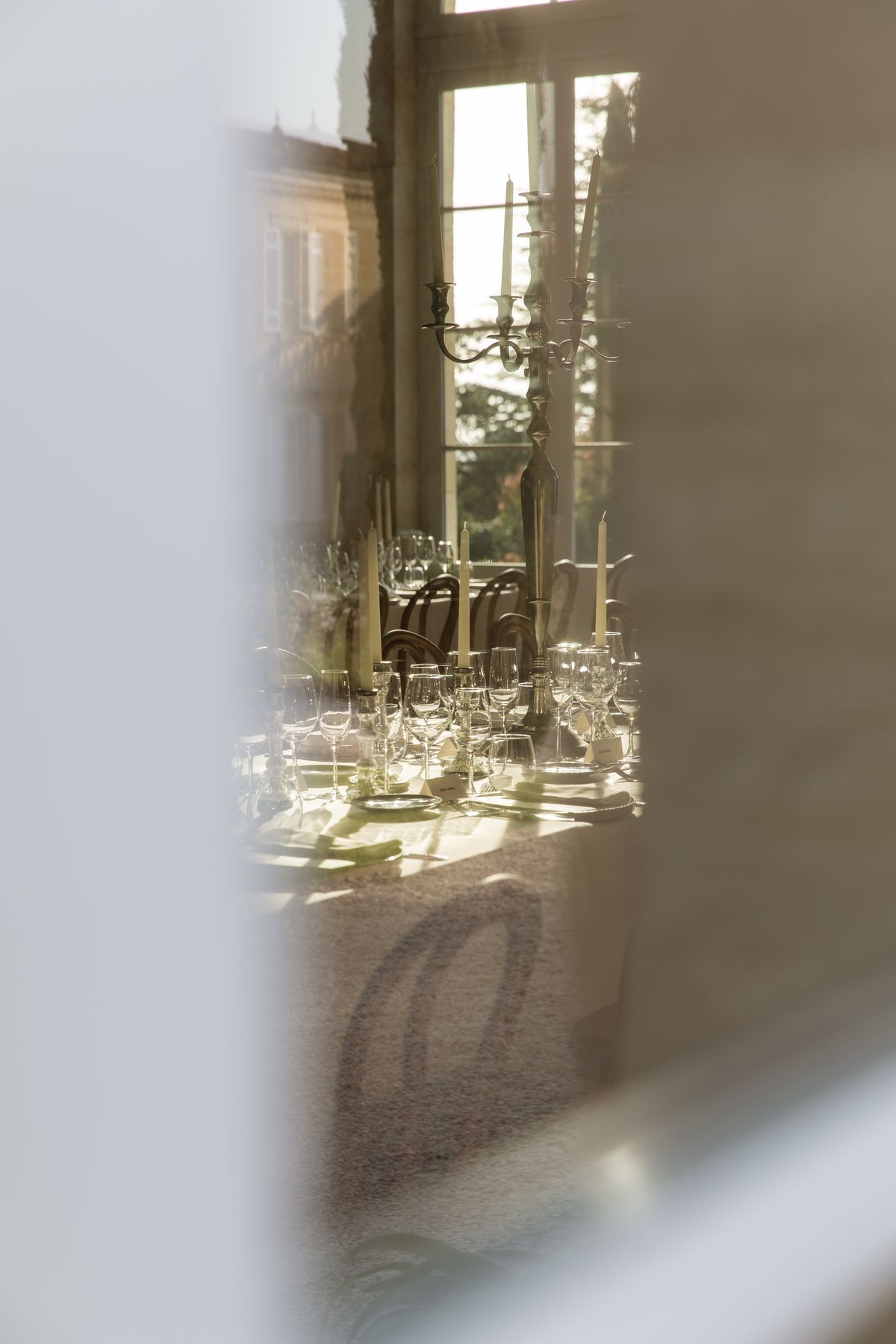 Reception table glimpsed through a doorway at Chateau Gassies, Nouvelle-Aquitaine
