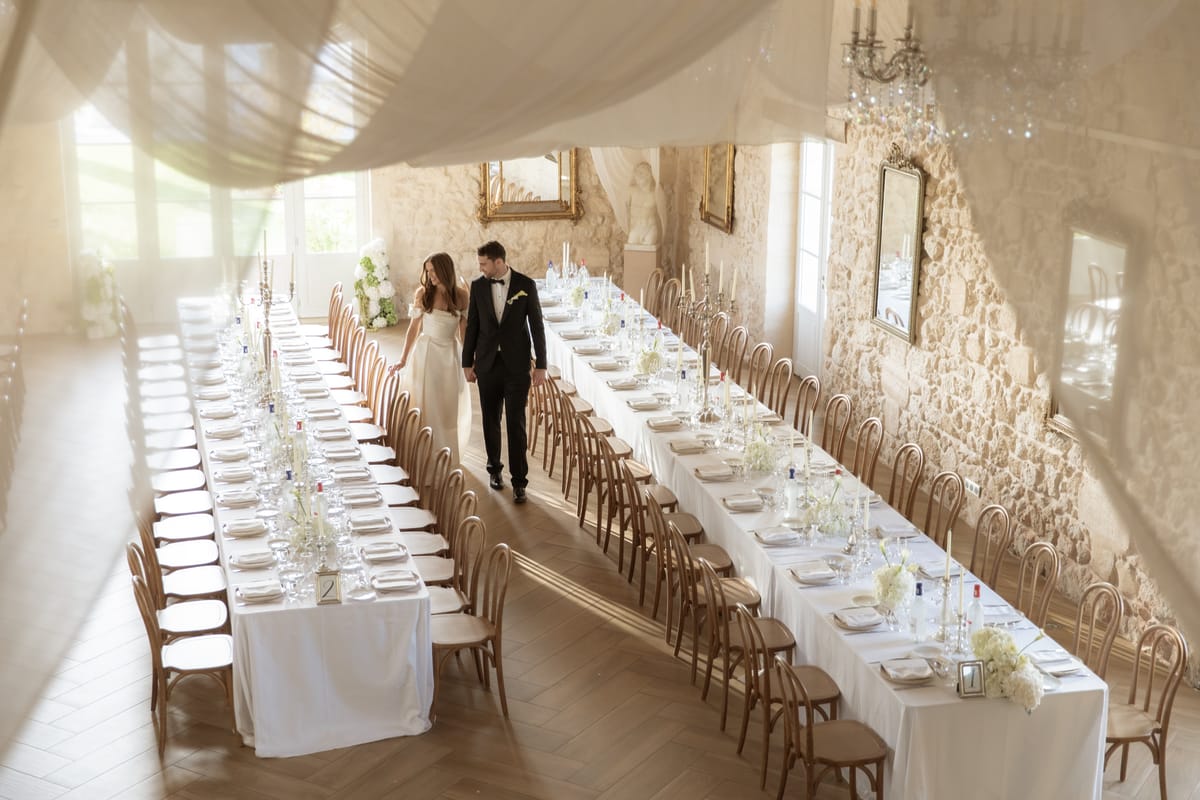 Draped reception hall with long banquet tables at Chateau Gassies, Nouvelle-Aquitaine