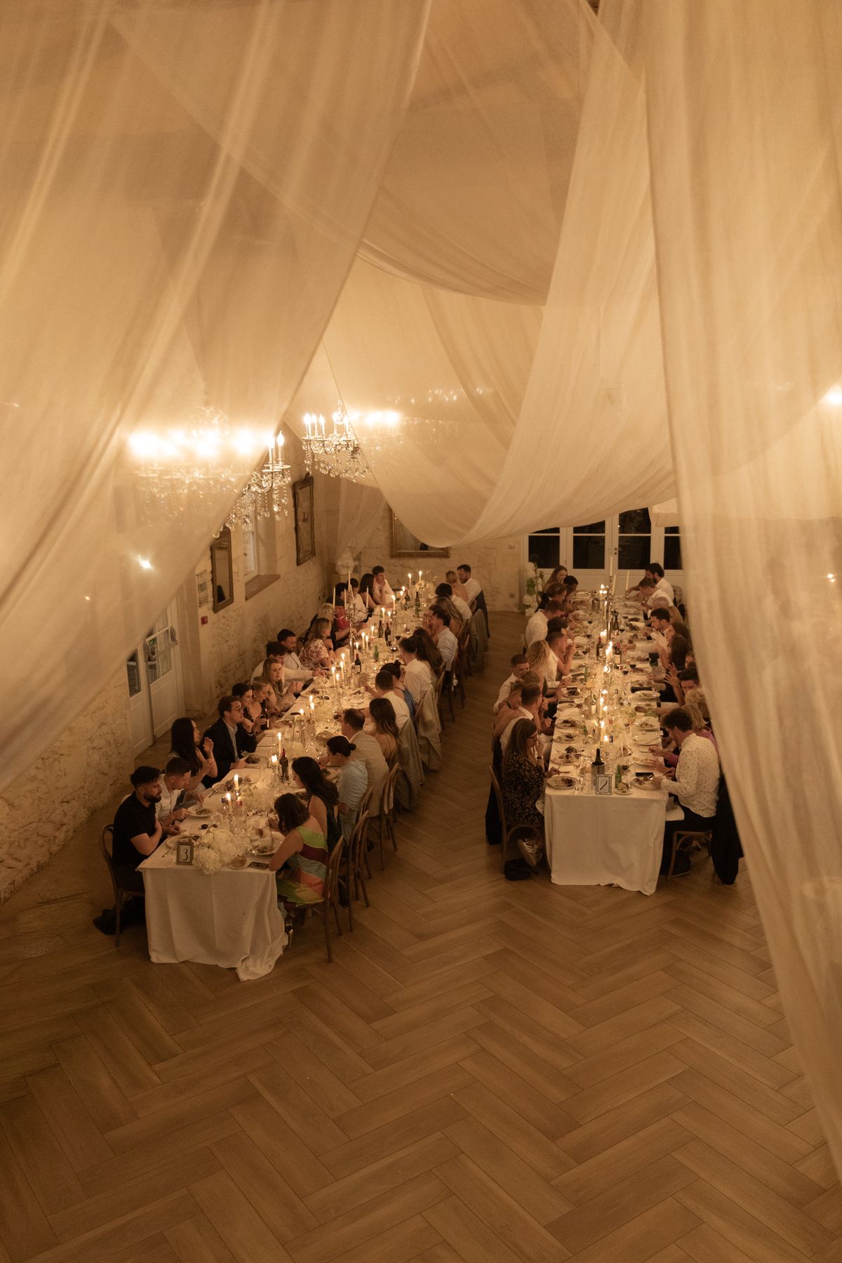 Candle-lit reception dinner under draped ceiling at Chateau Gassies, Nouvelle-Aquitaine