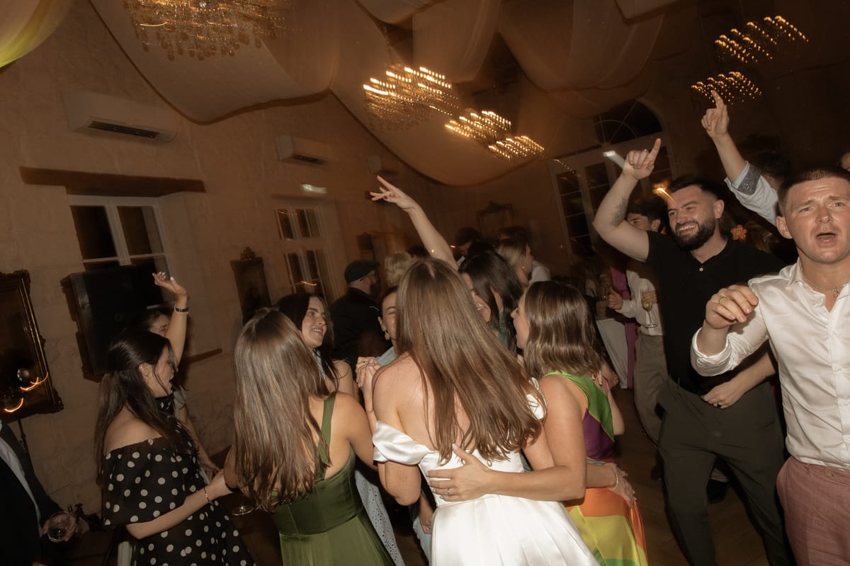 Bride dancing with friends at the reception at Chateau Gassies, Nouvelle-Aquitaine