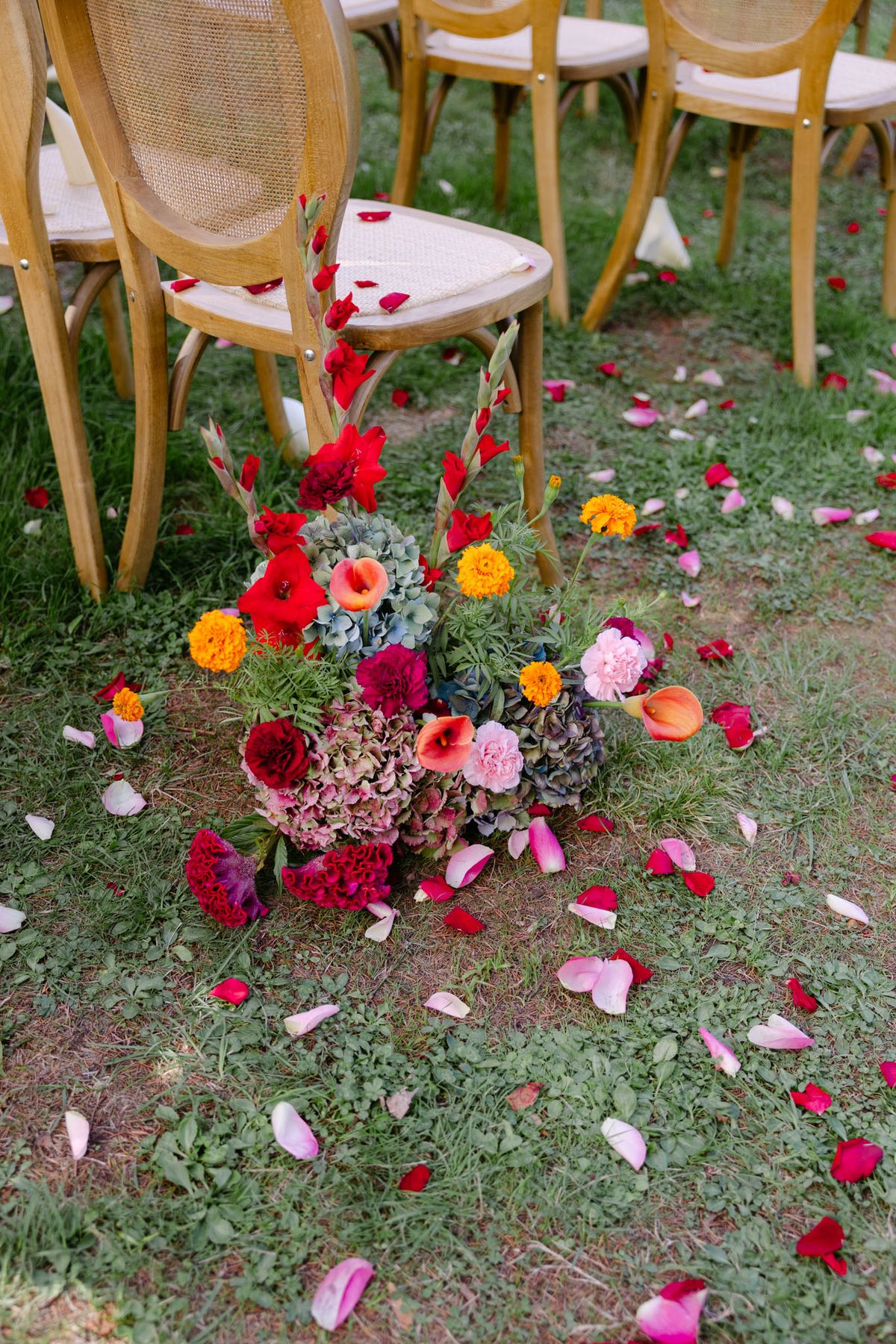 Colourful wedding details at Domaine de Perrotin in shades of fuchsia, raspberry, sky blue and orange, from the florals and tablescapes of Rooa and Mark's celebration