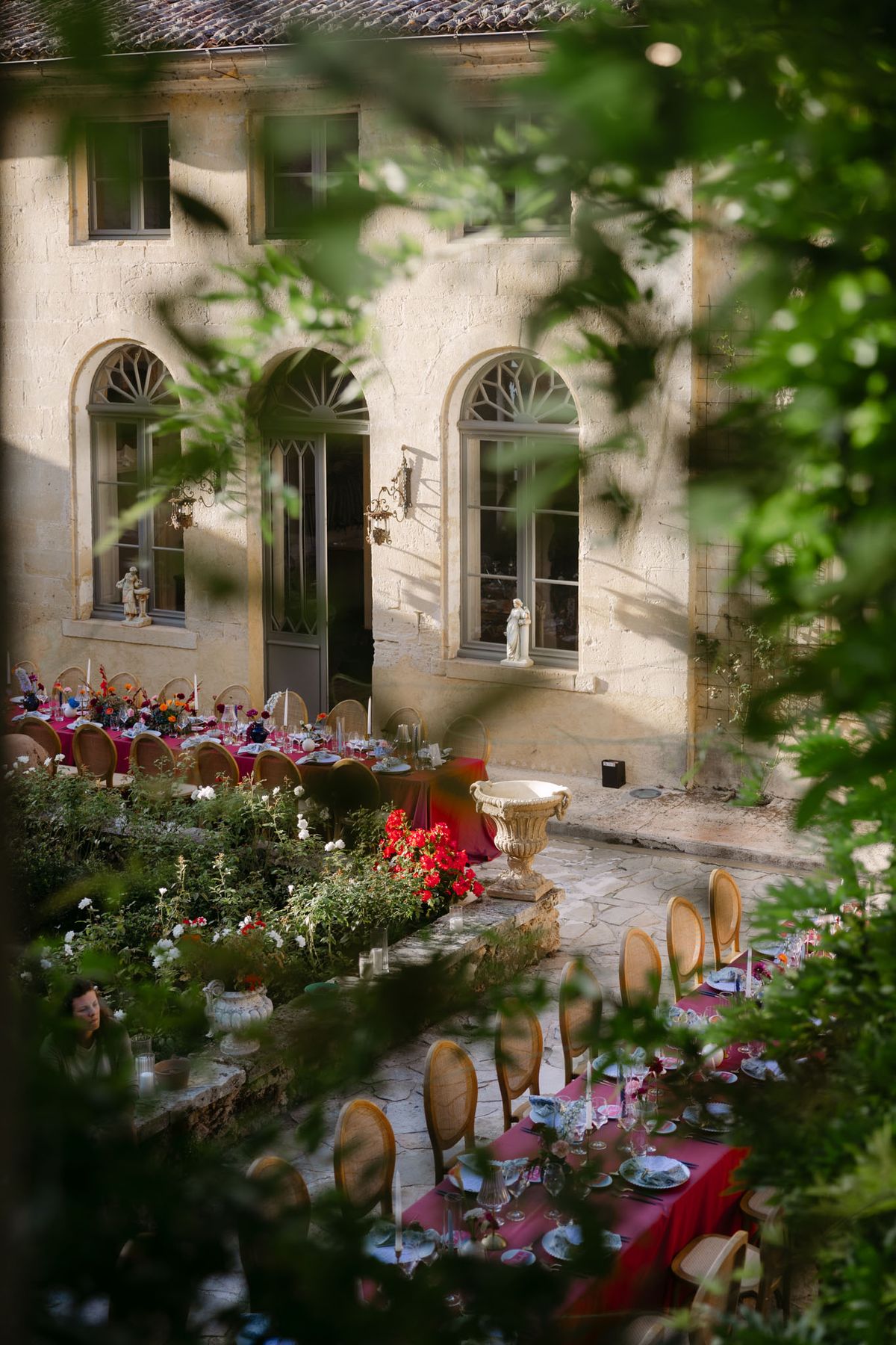 Colourful wedding details at Domaine de Perrotin in shades of fuchsia, raspberry, sky blue and orange, from the florals and tablescapes of Rooa and Mark's celebration