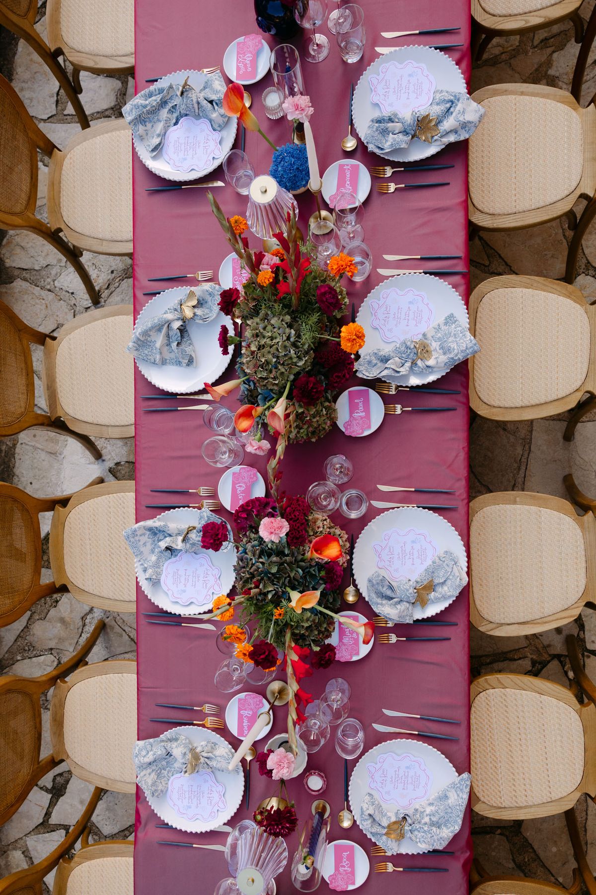 Colourful wedding details at Domaine de Perrotin in shades of fuchsia, raspberry, sky blue and orange, from the florals and tablescapes of Rooa and Mark's celebration