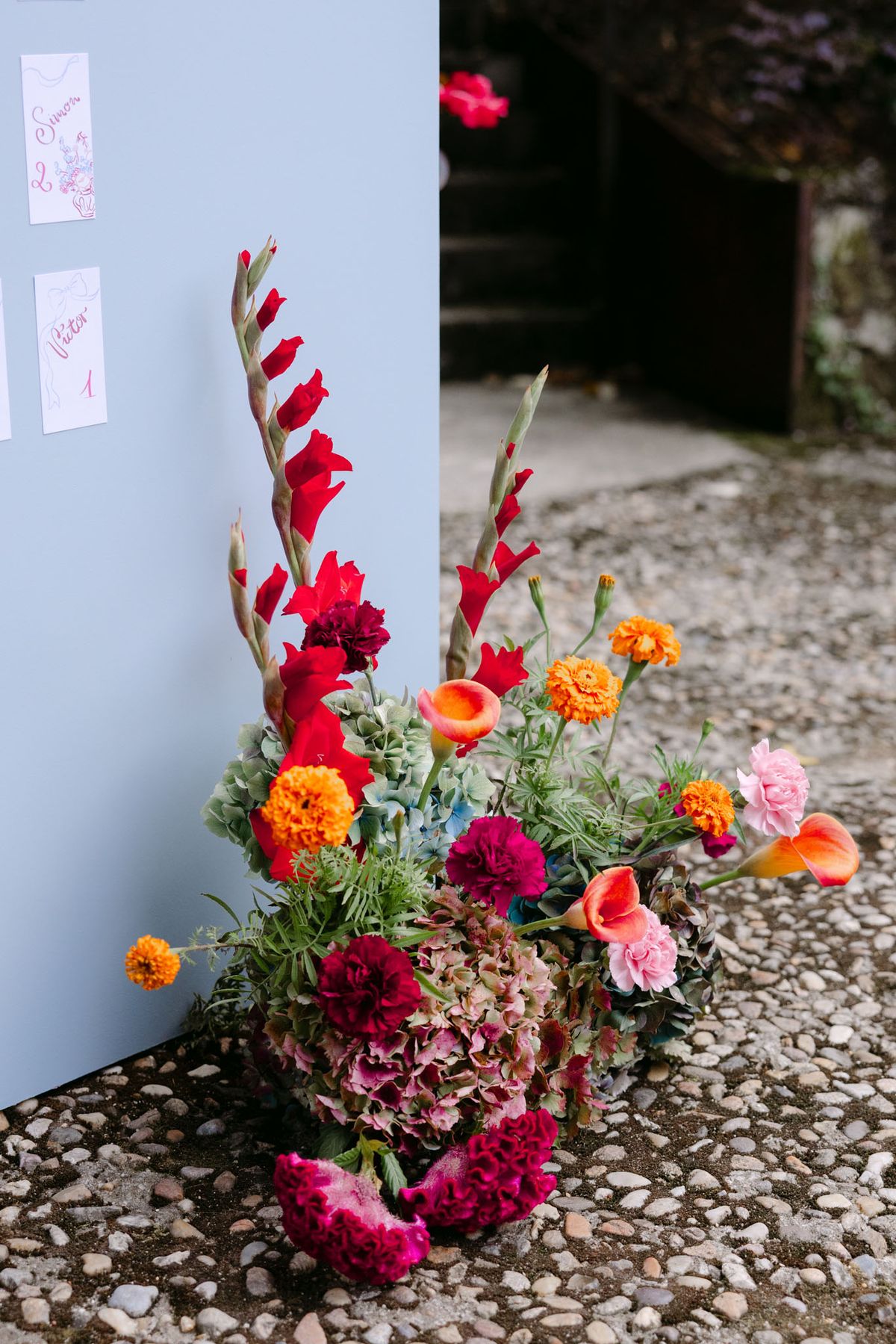 Colourful wedding details at Domaine de Perrotin in shades of fuchsia, raspberry, sky blue and orange, from the florals and tablescapes of Rooa and Mark's celebration