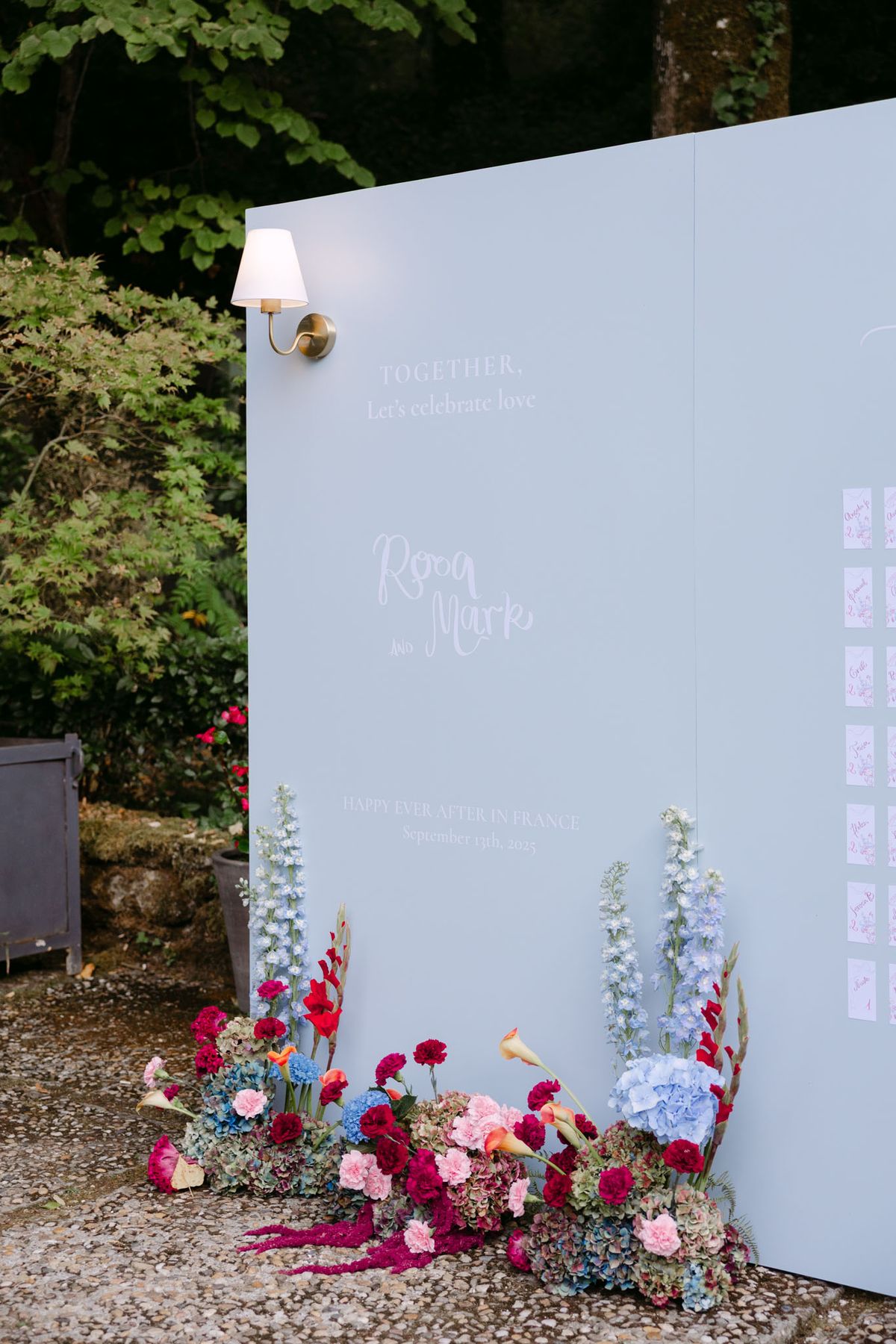 Colourful wedding details at Domaine de Perrotin in shades of fuchsia, raspberry, sky blue and orange, from the florals and tablescapes of Rooa and Mark's celebration