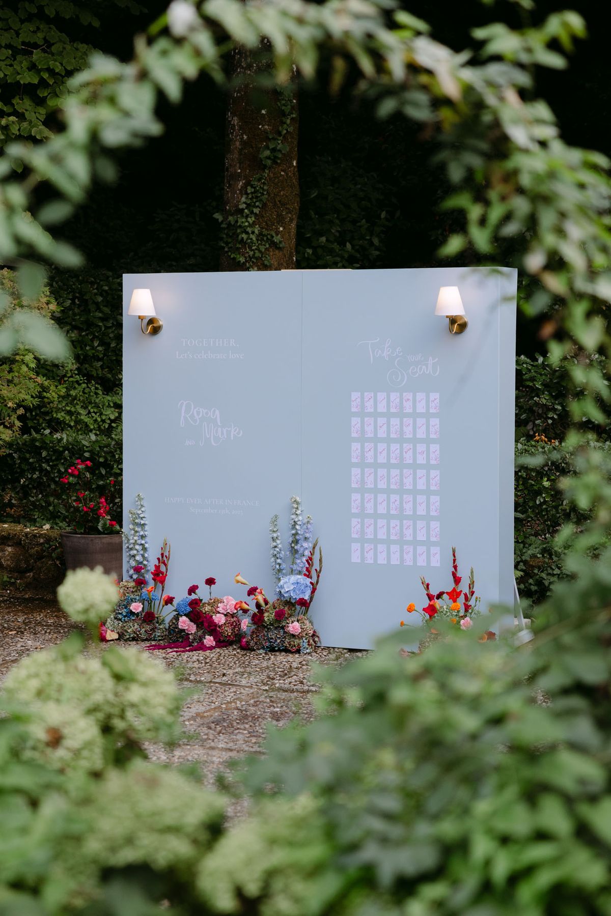 Colourful wedding details at Domaine de Perrotin in shades of fuchsia, raspberry, sky blue and orange, from the florals and tablescapes of Rooa and Mark's celebration