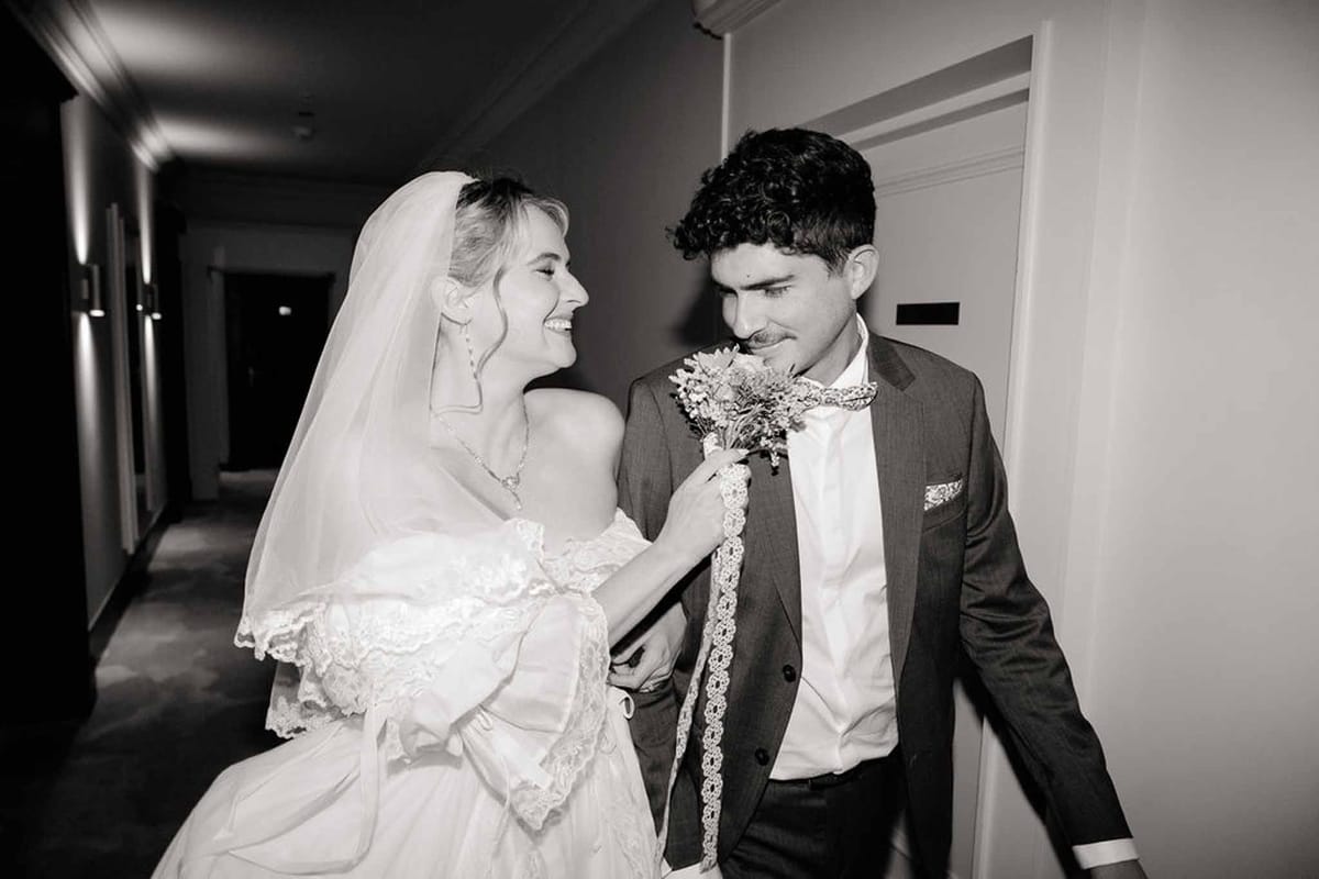 Couple laughing in hotel hallway in black and white at Palace de Menthon Annecy