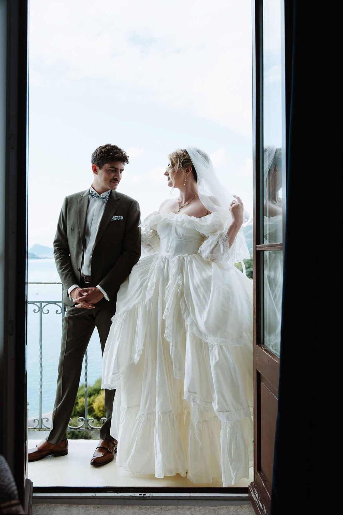Couple on balcony overlooking Lake Annecy at Palace de Menthon
