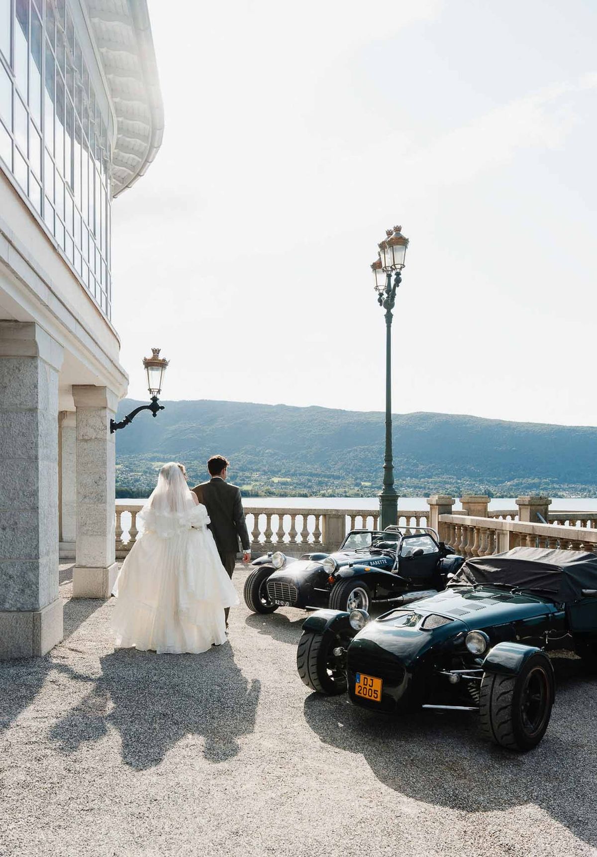 Couple with vintage sports cars on terrace overlooking Lake Annecy at Palace de Menthon