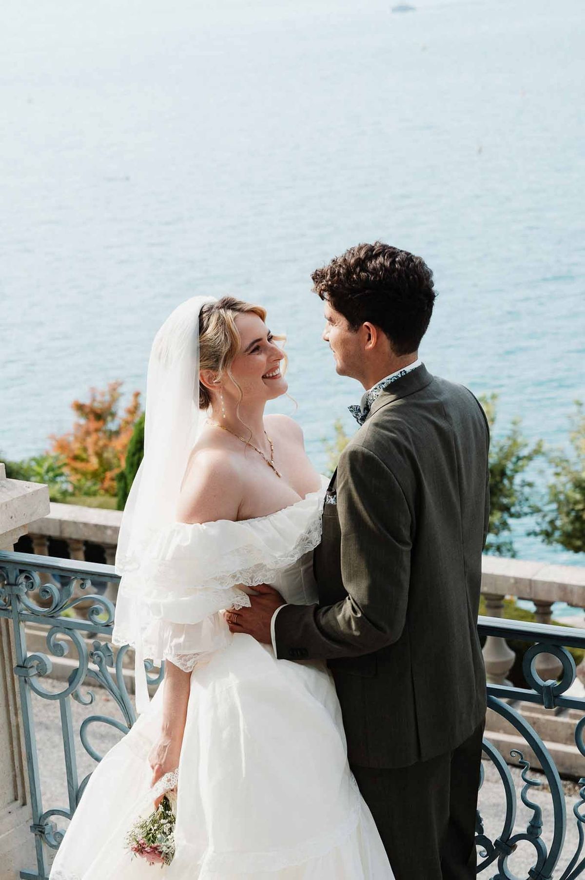 Couple embracing on terrace with Lake Annecy behind at Palace de Menthon