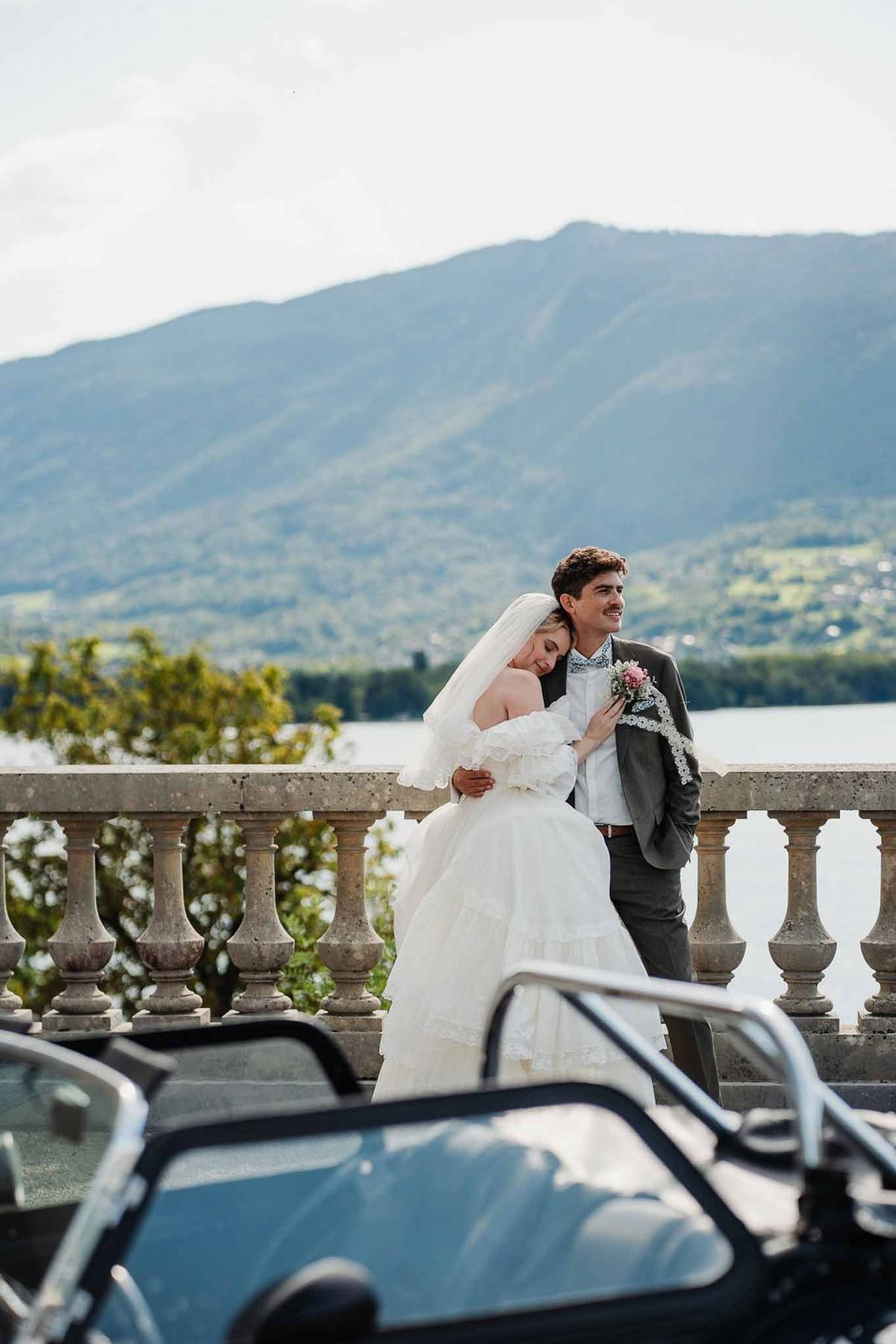 Couple at balustrade with vintage car and Lake Annecy view at Palace de Menthon