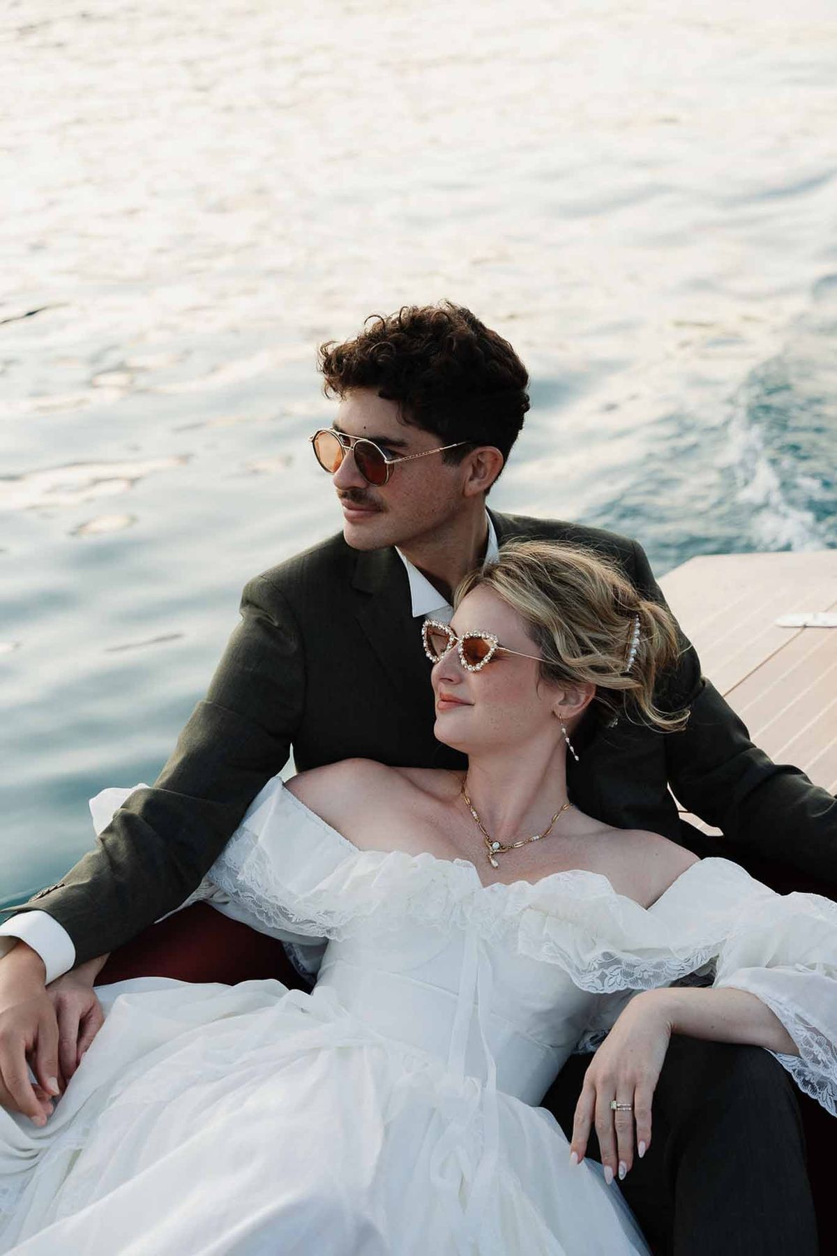 Couple in sunglasses relaxing on speedboat on Lake Annecy at Palace de Menthon