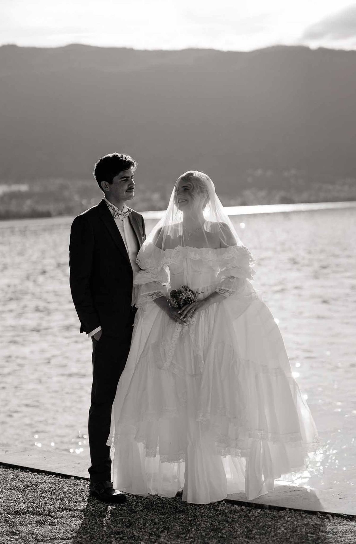 Couple on lakeside promenade at sunset in black and white at Palace de Menthon Annecy