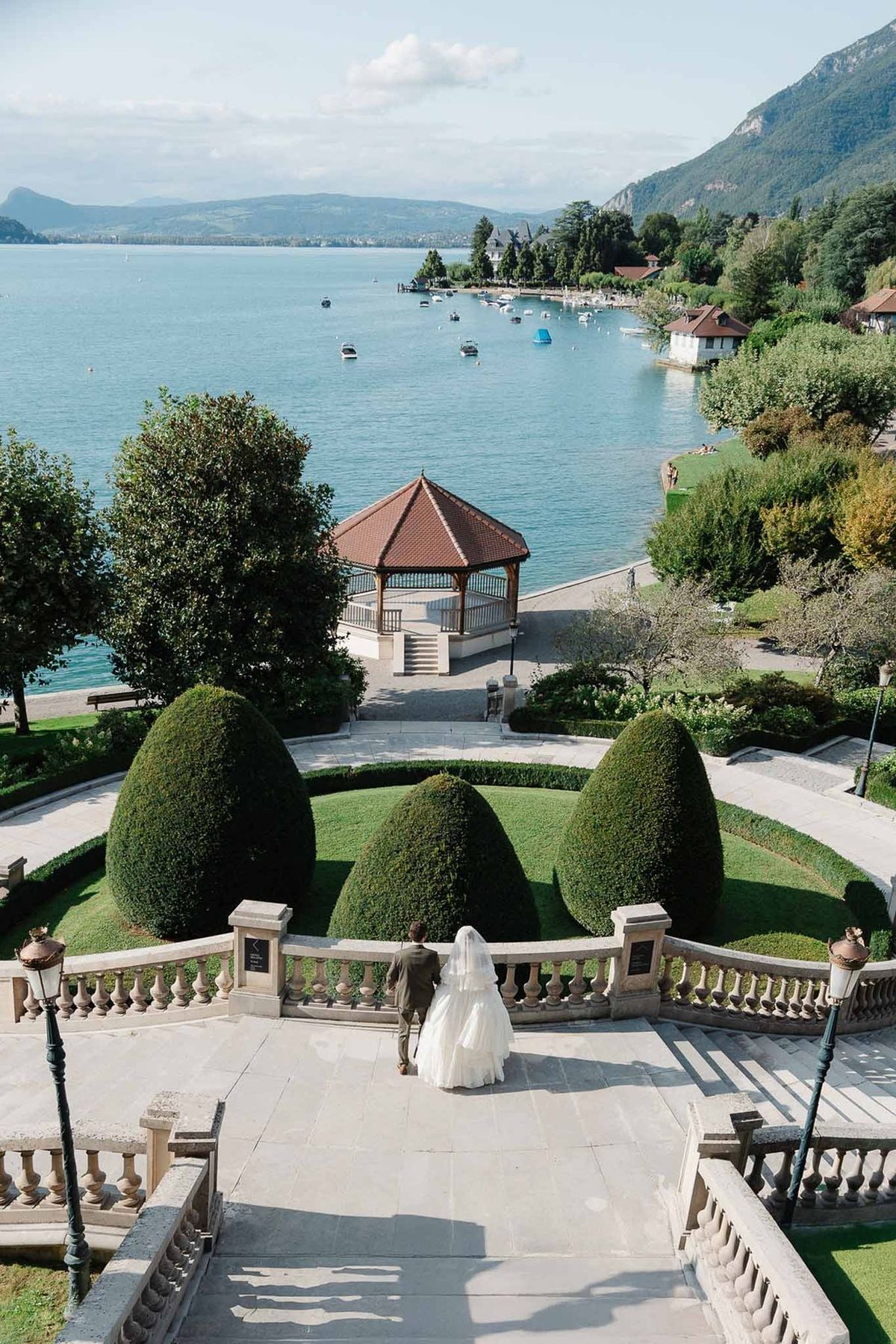 Panoramic view of Lake Annecy from Palace de Menthon staircase with bride descending