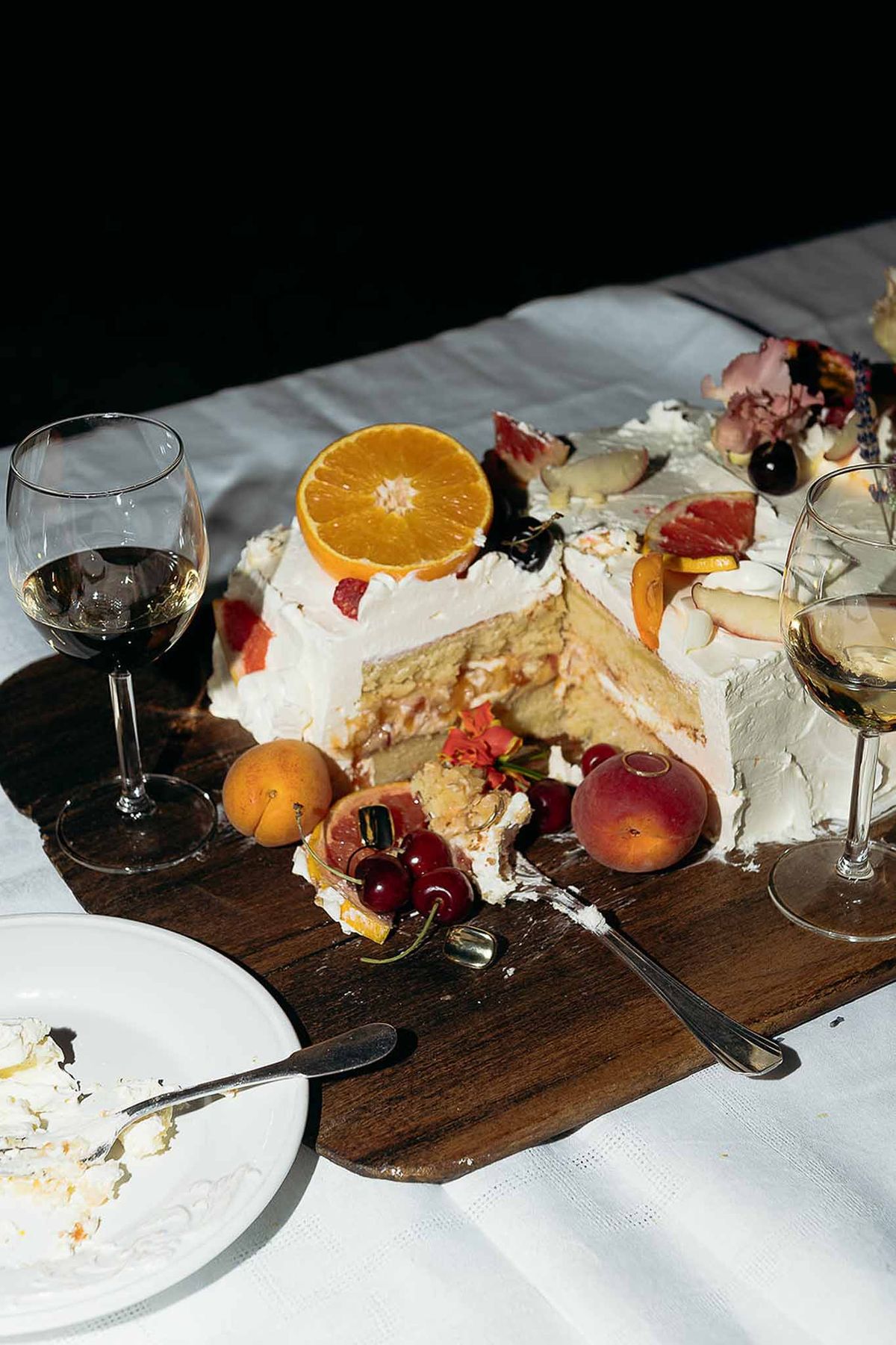 Close-up of fruit-topped cake slice with champagne at the Bastide des Barattes market reception