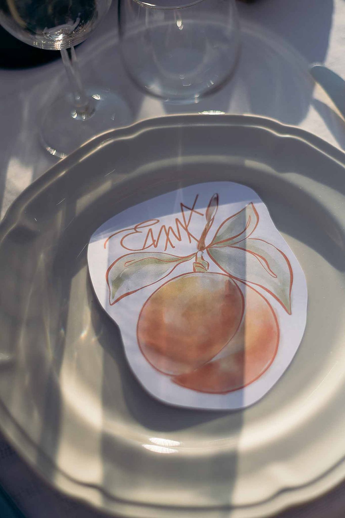 Place card and plate setting at golden hour, graphic stationery on the market reception table, Bastide des Barattes