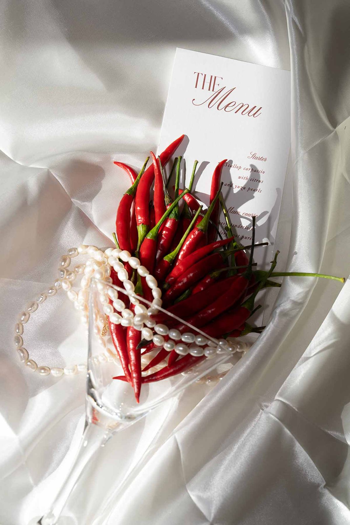 Menu card with pearl and red chilli spice accessories